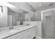 Bright bathroom featuring double vanity with quartz countertop and glass shower at 7699 Sw 74Th Loop, Ocala, FL 34481