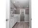 Bathroom featuring double sinks, sleek cabinets, and a glass-enclosed walk-in shower at 7699 Sw 74Th Loop, Ocala, FL 34481