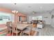 Open concept dining area features stylish furniture, ample space, and seamlessly connects to the living room at 7699 Sw 74Th Loop, Ocala, FL 34481