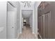 Inviting entryway featuring neutral walls, stylish light fixture, and wood-look tile flooring flowing into the home at 7699 Sw 74Th Loop, Ocala, FL 34481