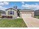 Beautiful home with well-maintained lawn, attached garage, and colorful landscaping at 7699 Sw 74Th Loop, Ocala, FL 34481