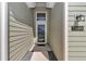 View of the front entrance featuring a glass door, decorative transom window, and clear house number at 7699 Sw 74Th Loop, Ocala, FL 34481