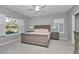 Serene main bedroom features soft carpet, plantation shutters, and a king-size bed with matching furniture at 7699 Sw 74Th Loop, Ocala, FL 34481