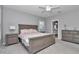 Comfortable main bedroom with carpet, shutters, and a view of the ensuite bathroom at 7699 Sw 74Th Loop, Ocala, FL 34481
