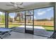 A screened patio with outdoor furniture and a view of the expansive lawn at 7699 Sw 74Th Loop, Ocala, FL 34481