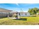 Serene backyard featuring a cozy gazebo set on a gravel foundation and mature landscaping at 859 Neuse Ave, Orlando, FL 32804