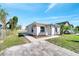 View of the side of the house showing a walkway with brick pavers and landscaping at 859 Neuse Ave, Orlando, FL 32804