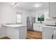 Bright kitchen with stainless steel appliances, and white countertops and cabinetry at 859 Neuse Ave, Orlando, FL 32804