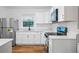 Bright kitchen features white cabinetry, stainless steel appliances, and granite countertops at 859 Neuse Ave, Orlando, FL 32804