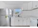 Bright kitchen featuring stainless steel appliances, white cabinets, and a stylish sink at 859 Neuse Ave, Orlando, FL 32804