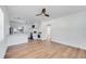 Bright and open-concept living area with modern kitchen features, stainless steel appliances, and light wood flooring at 859 Neuse Ave, Orlando, FL 32804