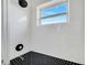 Shower featuring white subway tiles and black hexagon tiles at 859 Neuse Ave, Orlando, FL 32804