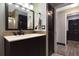 Bathroom featuring vanity with a modern sink, updated light fixtures, and stylish dark door at 868 Shell Ln, Longwood, FL 32750
