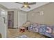 Bedroom features a closet, wood-look flooring, and a cozy chair for relaxation at 868 Shell Ln, Longwood, FL 32750