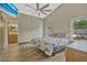 Bright bedroom with natural light, wood-look flooring, and a comfortable queen-sized bed at 868 Shell Ln, Longwood, FL 32750