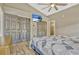 Bedroom featuring a closet, wood-look flooring, and a modern TV for entertainment at 868 Shell Ln, Longwood, FL 32750