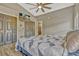 Well-lit bedroom features storage, wood-look flooring, and a modern TV for enjoyment at 868 Shell Ln, Longwood, FL 32750