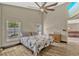 Sunlit bedroom boasts wood-look flooring, offering views of the lush landscape from two windows at 868 Shell Ln, Longwood, FL 32750