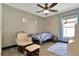 Relaxing bedroom features a window, ceiling fan, and wood-look flooring to create a cozy ambiance at 868 Shell Ln, Longwood, FL 32750