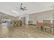 Bright open floor plan with a kitchen island and adjacent dining area, complete with modern ceiling fan and skylight at 868 Shell Ln, Longwood, FL 32750