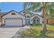 Inviting single Gathering home featuring a well manicured lawn, blue door and white facade at 868 Shell Ln, Longwood, FL 32750