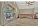 Living room with sliding glass doors to patio, ceiling fan, wood floors and large leather couch at 868 Shell Ln, Longwood, FL 32750