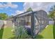 The screened-in pool area is adjoined with artificial turf and lovely plants for outdoor relaxation and enjoyment at 868 Shell Ln, Longwood, FL 32750