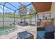 Screened pool area with custom outdoor kitchen, elegant patio furniture and lush landscaping at 868 Shell Ln, Longwood, FL 32750