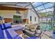 Outdoor screened-in patio featuring a heated pool, lounge furniture, and an outdoor kitchen at 868 Shell Ln, Longwood, FL 32750