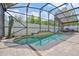 A private screened pool features lush landscaping, ample seating, and a charming water feature at 868 Shell Ln, Longwood, FL 32750