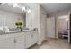Bright bathroom features a double vanity with white cabinetry and tile flooring at 8816 Cruden Bay Ct, Davenport, FL 33896
