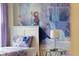 Bedroom with a fairytale mural backdrop with a side table and a lamp at 8816 Cruden Bay Ct, Davenport, FL 33896