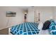 Comfortable bedroom with stylish blue and white comforter set, TV, and neutral walls at 8816 Cruden Bay Ct, Davenport, FL 33896