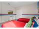 A room has twin beds, super hero decor, and a dresser with a TV for entertainment at 8816 Cruden Bay Ct, Davenport, FL 33896