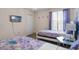 bedroom with two beds, a tv, closet and neutral paint at 8816 Cruden Bay Ct, Davenport, FL 33896