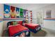 The themed bedroom offers two beds, fun superhero wall decor, and an attached bathroom at 8816 Cruden Bay Ct, Davenport, FL 33896