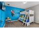 Vibrant bedroom featuring a bunk bed, playful decor, and a colorful theme at 8816 Cruden Bay Ct, Davenport, FL 33896