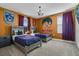 A cozy, themed bedroom showcases twin beds, a quirky chandelier, and a unique Harry Potter wall design at 8816 Cruden Bay Ct, Davenport, FL 33896