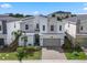 Stunning two-story home boasting stone and modern architectural details, plus a well-kept front lawn at 8816 Cruden Bay Ct, Davenport, FL 33896