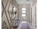 Stylish foyer featuring a decorated wall, a modern light fixture, and a welcoming entryway at 8816 Cruden Bay Ct, Davenport, FL 33896
