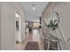 Inviting foyer with decorative wall trim, modern accents, and a view into the kitchen and living area at 8816 Cruden Bay Ct, Davenport, FL 33896