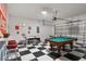 Fun game room with a checkerboard floor, pool table, and foosball table, perfect for entertaining at 8816 Cruden Bay Ct, Davenport, FL 33896