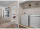 Conveniently located laundry room with modern washer and dryer, shelving, and ample space at 8816 Cruden Bay Ct, Davenport, FL 33896