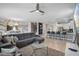 Open-concept living room boasts stylish decor, a sectional sofa, and seamless flow to the kitchen and dining area at 8816 Cruden Bay Ct, Davenport, FL 33896