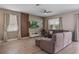 Cozy living room with wood accent wall features tile floors, a comfortable sofa, and a large screen television at 8816 Cruden Bay Ct, Davenport, FL 33896