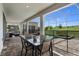 Covered patio with outdoor dining table, screened-in pool, and view of the backyard at 8816 Cruden Bay Ct, Davenport, FL 33896