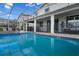 Inviting screened-in pool with spacious deck, plenty of room for lounging, and sunny views at 8816 Cruden Bay Ct, Davenport, FL 33896
