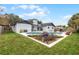 Charming backyard oasis featuring a pool, well-manicured lawn, and beautiful landscaping at 9235 Everwood St, Orlando, FL 32825