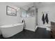 Modern bathroom with a freestanding tub, glass-enclosed shower, and sleek fixtures at 9235 Everwood St, Orlando, FL 32825