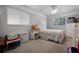 Cozy bedroom features a bed, nightstand, and windows to bring in natural light at 9235 Everwood St, Orlando, FL 32825